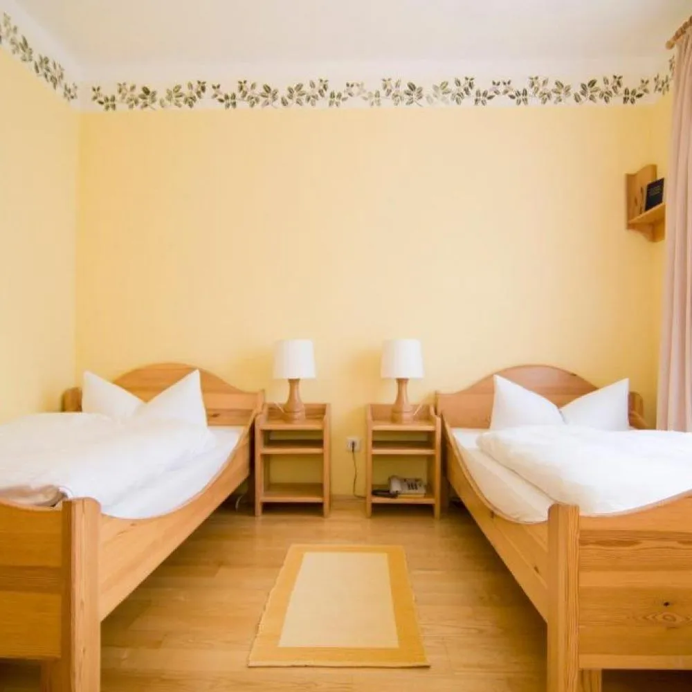 Zimmer mit zwei Einzelbetten (Twin-Betten) und Nachttischen